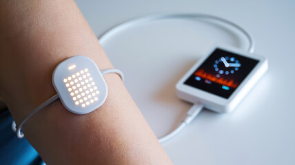 a sleek wearable device is attached to a wrist, displaying digital patterns, connected to a portable