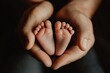 © Ева Поликарпова - A pair of hands cradling the tiny feet of an infant, conveying love and care