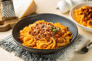 Wall Mural - Top view of plate with Tagliatelle al ragu  - long, flat egg pasta with a meat sauce or Bolognese sauce and parmesan cheese, served with rosemary.