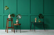 © Pixel-Shot - Vases and wooden hand with monstera leaves on tables near green wall