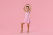© New Africa - Little ballerina practicing dance moves on pink background