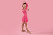 © New Africa - Little ballerina practicing dance moves on pink background