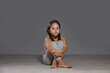 © New Africa - Orphanage concept. Sad girl sitting on floor indoors