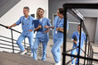 © New Africa - Healthcare workers walking up stairs in hospital