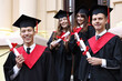 © New Africa - Graduation ceremony. Happy students with diplomas outdoors, selective focus
