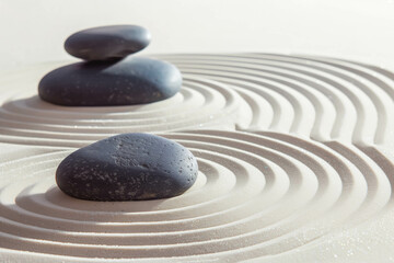 zen garden meditation stone background with stones and lines in sand for relaxation balance and harm