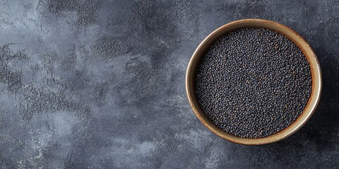 Poster - Poppy seeds in a bowl on a grey table, seen from above. Copyspace available.