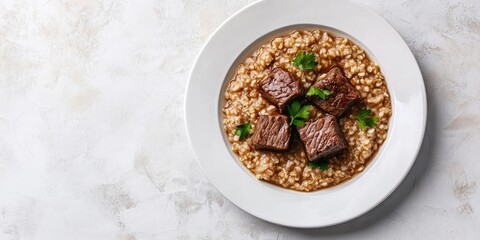 Poster - Buckwheat porridge accompanied by three pieces of boiled beef on a white plate, against a light background. Copyspace.