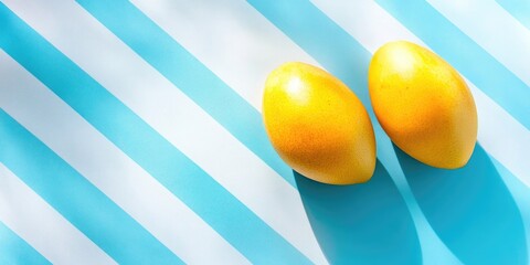 Canvas Print - Fresh ripe mango on a bright blue and white striped backdrop with copyspace, ideal for food-themed designs and summer concept visuals.