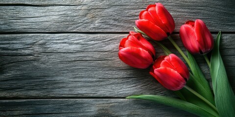 Aufkleber - Red tulips on a wooden surface.