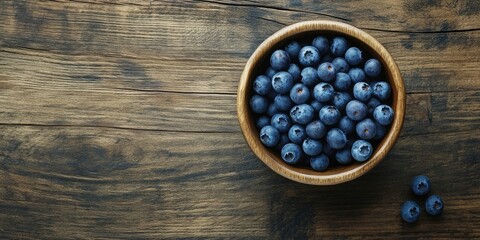 Aufkleber - Blueberries in a circular wooden bowl on a wooden surface copy space.