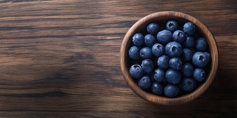 Aufkleber - Blueberries in a circular wooden bowl on a wooden surface copy space.