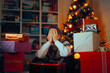 © nicoletaionescu - Upset Stressed woman Surrounded by Wrapped Christmas Gifts. Disappointed lady feeling overwhelmed with arranging the gift boxes