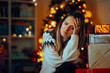© nicoletaionescu - Sad Woman Being Emotional Feeling the Holiday Blues at Home. Unhappy lady being all alone during Christmas