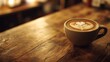 © Sinechana - 10.A detailed coffee shop setting, featuring a cup of coffee with intricate latte art on a warm wooden table. The blend of earthy tones from the table and the soft lighting creates a cozy, comforting