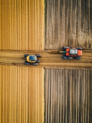Aufkleber - Robotic machines are actively engaged in planting and harvesting crops in a cultivated field under clear blue skies. Generative AI