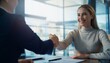 © Sain - Happy young business woman bank manager handshaking client at meeting. Smiling female hr hiring recruit at job interview, insurance agent, lawyer making contract deal at work with business