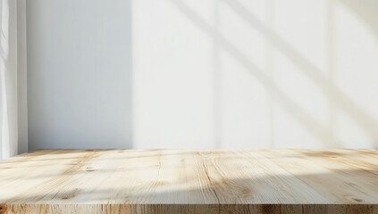 Wall Mural - empty light wood table against a white wall with natural shadows