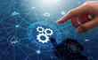 © tadamichi - Automation of business or robotic process RPA technology. Transfer of data between application. Businessman touching gears icon on network connection.