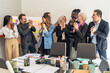 © Lomb - Creative multicultural business team laughing brainstorming session modern office diverse professional collaboration innovative planning