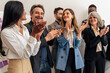 © Lomb - Enthusiastic multicultural business team celebrating success modern office diverse workforce authentic professional achievement