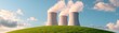 © Chanoknan - Nuclear power plant cooling towers emitting steam against a blue sky and grassy hill.