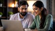 © N7 - An Indian couple collaborating on a business idea in a cozy home office.