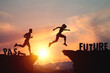 © Midnight Studio - Self-improvement, past and future concept. Silhouette of person jumping between cliffs with words PAST and FUTURE on sunset light. Represents change, and determination to confidently move into future.