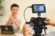 © Prathankarnpap - Close up of a camera filming interview of a successful entrepreneur in his office