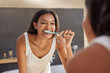 © Rido - Indian woman brushing teeth in the morning