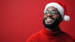 © Anastasiia K. - joyful handsome black man in santa claus hat isolated on bright red background, copy space. man in new year christmas hat