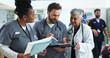 © peopleimages.com - Healthcare, reading and group with tablet, hospital and diversity of staff, documents and collaboration. Teamwork, professional and people with paperwork, women and doctor with intern and clinic