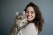 © Andrii  - Professional Vet Holding Cat for Health Checkup