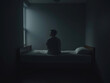 © Cozy Coffee Bar - Lonely man sitting on bed contemplating window light in dark room