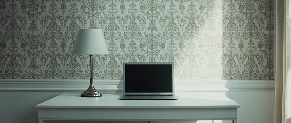 Wall Mural - A workstation with a laptop, and desk lamp on a white table in a minimalist interior with a patterned wallpaper wall