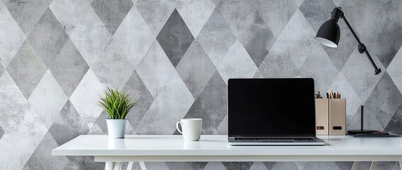 Wall Mural - a modern home office desk with a laptop and coffee cup on a white table against a wall decorated with a geometric pattern wallpaper