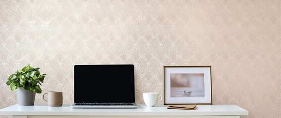 Wall Mural - a modern home office desk with a laptop and coffee cup on a white table against a wall decorated with a geometric pattern wallpaper
