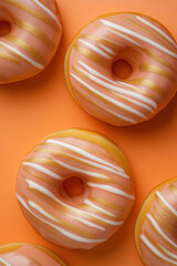 Wall Mural - collection of  freshly glazed donuts with peach color and white stripes arranged  on a solid background