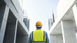 © JKLoma - Construction worker wearing a helmet at an industrial building site