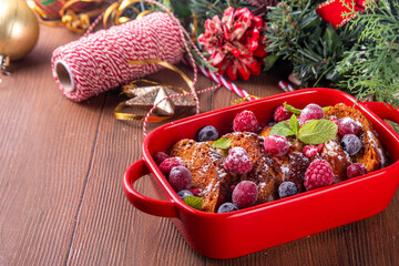 Christmas Morning French Toast Baking, holiday morning french toast casserole, sweet simple dessert with bread, egg and milk mixture and fresh berries