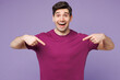 © ViDi Studio - Young shocked surprised overjoyed Caucasian man he wear violet t-shirt casual clothes point index finger on himself isolated on plain pastel light purple background studio portrait. Lifestyle concept.