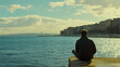 © cynz - A man sitting at the edge of a pier, staring at the water, his thoughtful expression capturing a state of reflection. 4k resolution, Cinematic Scene