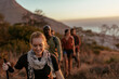 © Marko Geber - Group of friends hiking on a mountain trail at sunset
