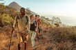 © Marko Geber - Group of friends hiking on a mountain trail at sunset