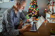 © Davor - Senior man shopping online with credit card during Christmas holidays