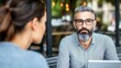 © Wp Background - Professional man with beard wearing glasses engaged in conversation with woman in cafe setting, showcasing modern communication and teamwork in a vibrant social atmosphere.