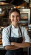 © novitasary - A smiling chef in a kitchen, wearing a uniform and apron, exuding confidence and warmth.