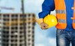© BillionPhotos.com - Safety workwear hold safety helmet at construction