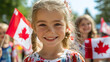 © Madlen Gray - Canada Day celebration with happy kids holding Canadian flags during Canada Day parade