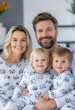 © Artsaba Family - Happy family in matching pajamas posing together in a cozy home, celebrating love and togetherness
